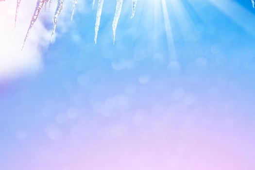 White icicles against the blue winter sky. photo