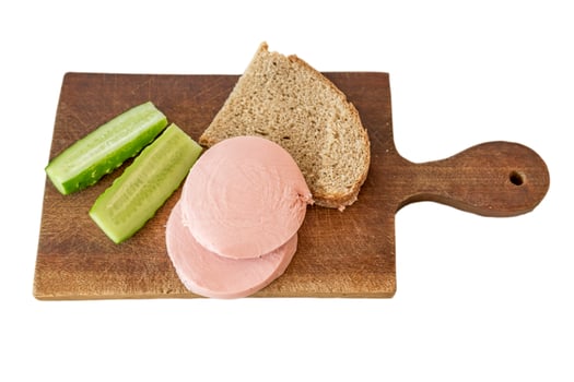 rye bread, cucumber and sausage on brown wooden desk on white background photo