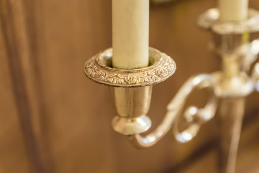 closeup of antique gold plated candelabrum with candle photo