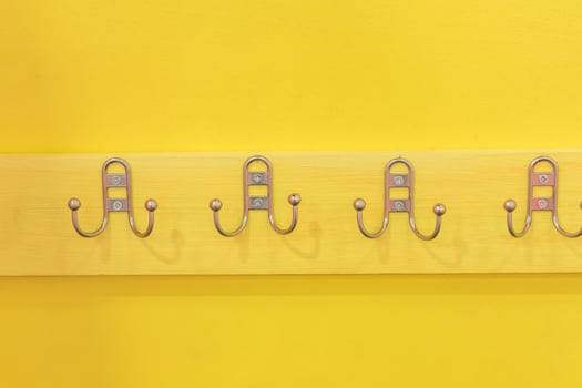Metal Hanger Hook on yellow wooden desk photo