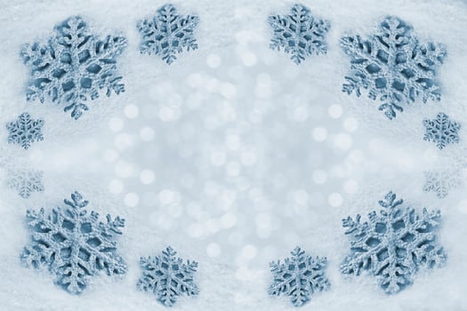 Glass toy snowflake on snow background. photo