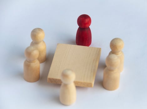 Wooden people figures having business meeting with customizable for text or ideas. photo