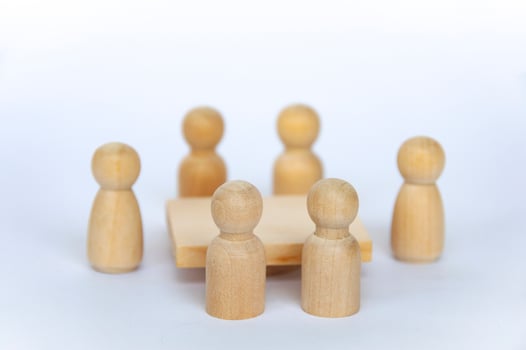 Wooden people figures having business meeting with customizable spare for text or ideas. photo