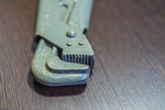 gas wrench on wooden table photo