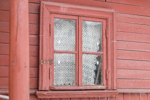 small window in wall of old wooden house photo