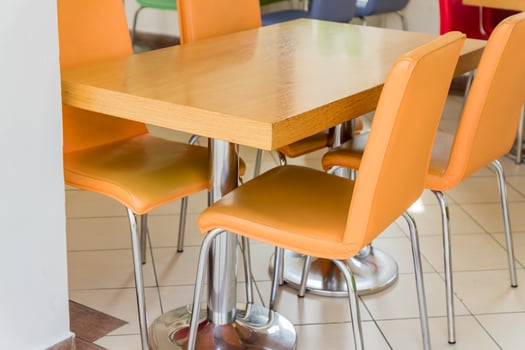 wooden table and orange leather chairs - cafe interior photo