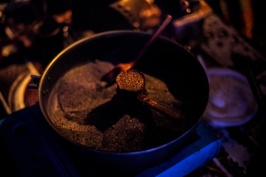 Coffee on sand. Coffee maker at festival. Preparation of strong drink. photo