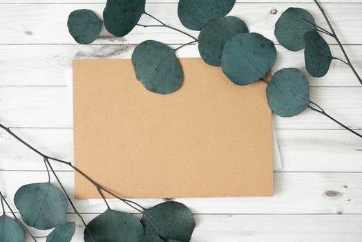 Mockup for a letter or a wedding invitation with leaves eucalyptus branches. photo