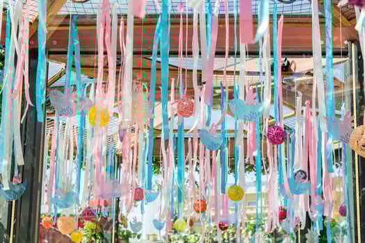 wedding or fectival decoration. Hanging ribbons, rattan balls and birds outdoors photo