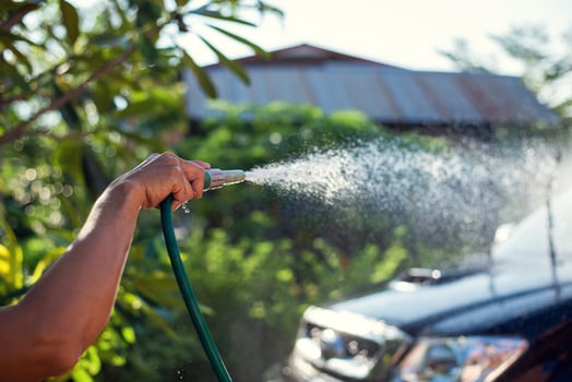 Hand holding car wash hose photo