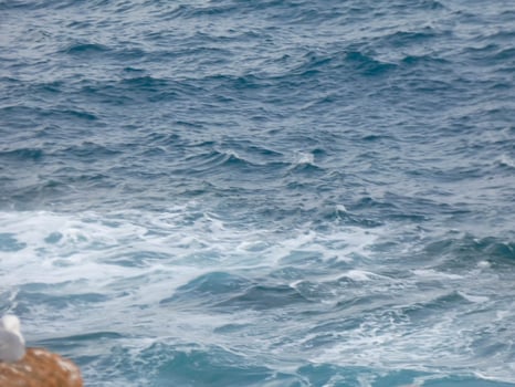 Rough sea, waves crashing against the rocks photo