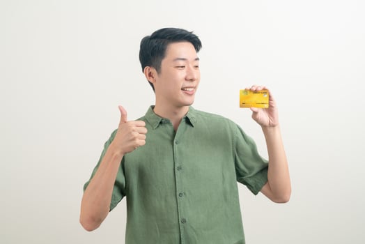 young Asian man holding credit card photo