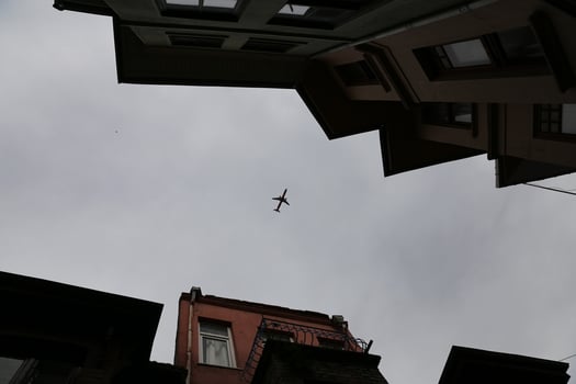 Airplane passing over Fener District in Istanbul, Turkey photo