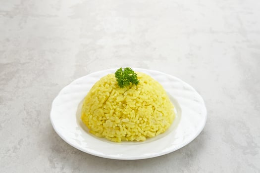 Nasi kuning, Indonesian traditional food, made from rice cooked with turmeric and coconut milk and spices. photo
