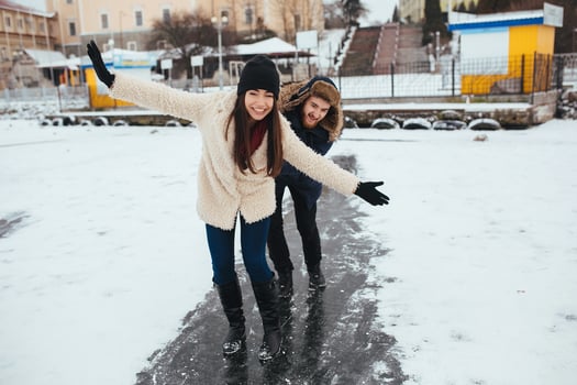 man and woman skate on ice photo
