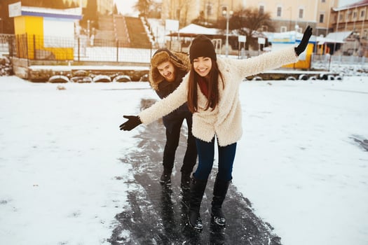 man and woman skate on ice photo