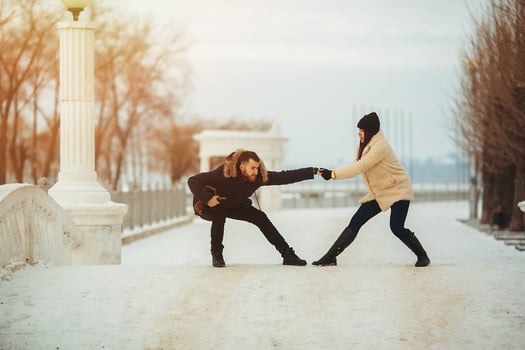 man and woman fooling around in park photo