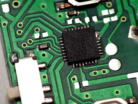 Green Printed Circuit Board PCB with some Surface Mount Device SMD components and chips photo