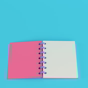 Pink notepad on bright blue background in pastel colors photo