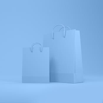 Shopping bags in blue background with space for text or design. photo