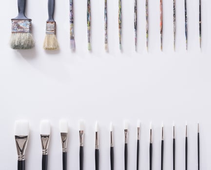 Paint brush on white parchment paper texture background photo