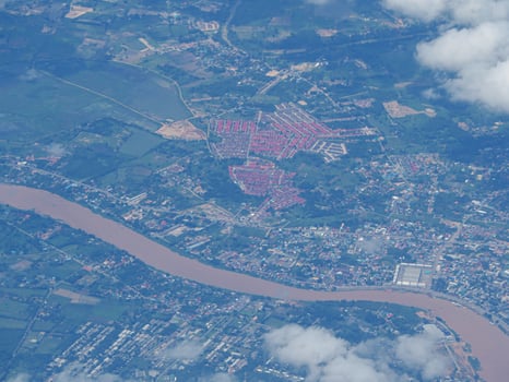 Aerial view of agricultural field and river seen through airplane window photo
