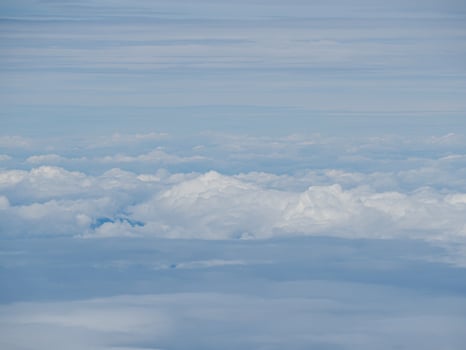 Aerial view of cloudscape seen through airplane window photo
