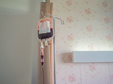 Blood bag for patient to treat anemia hanging in the patient room in the hospital photo