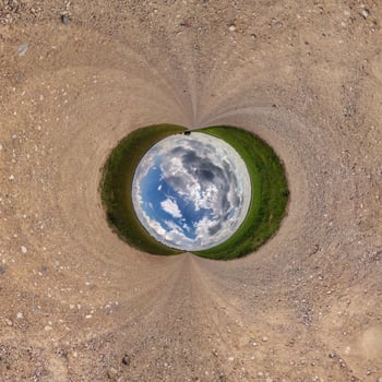 Inversion of blue little planet transformation of spherical panorama 360 degrees. Spherical abstract aerial view on road with awesome beautiful clouds. Curvature of space. photo