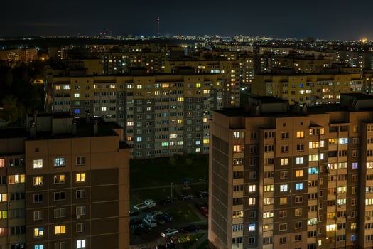 Night panorama of Light in the windows of a multistory building. life in a big city photo