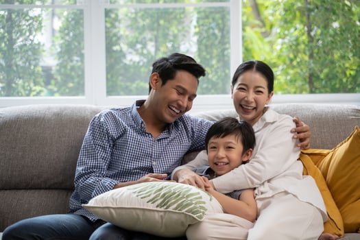 portrait of happy Asian family spending time together on sofa in living room. photo