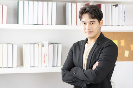 businessman smiling happy standing with arms crossed gesture at the office during business meeting. photo