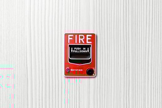 Fire alarm switch on white wood background photo