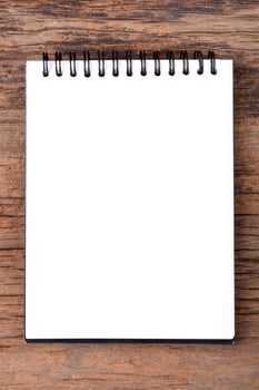 Blank empty notepad on wood background photo