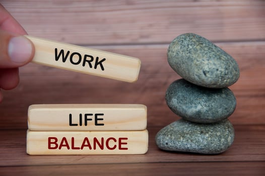 Work life balance text on wooden blocks with rocks and wooden cover background. photo