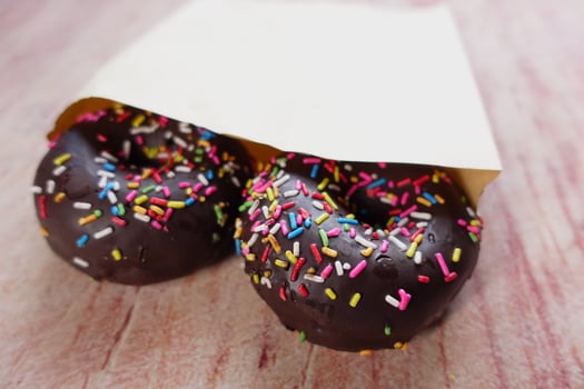 chocolate donuts on plate with copy space photo