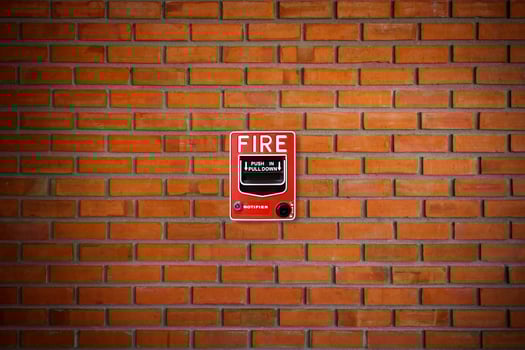 Fire alarm switch on brick wall texture background photo