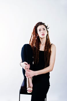 Studio shoot of girl in black with dreads on white background. photo