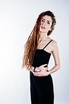 Studio shoot of girl in black with dreads on white background. photo