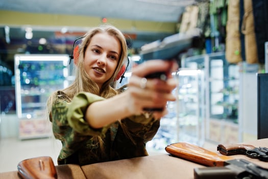 Shooting at the shooting range.The woman at the shooting range shot from gun. photo