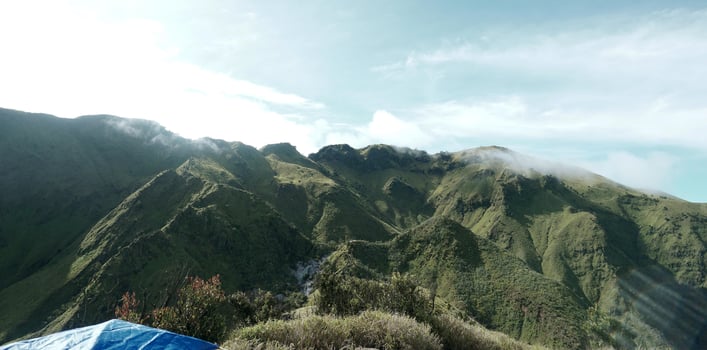 Green mountains and beautiful sky clouds under blue sky photo