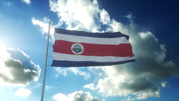 Flag of Costa Rica waving at wind against beautiful blue sky. 3d illustration photo