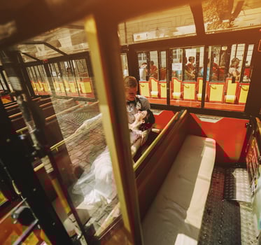 Bride and groom posing in a tour car photo