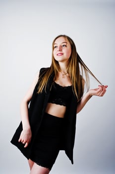Girl model in black wear posed at studio on white background. photo