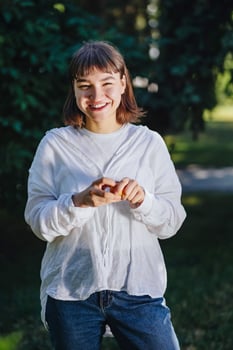 Portrait of happy smiling woman in casual outfit posing at the park. photo
