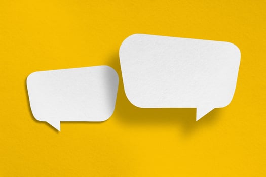speech balloon shape white paper isolated on yellow background photo