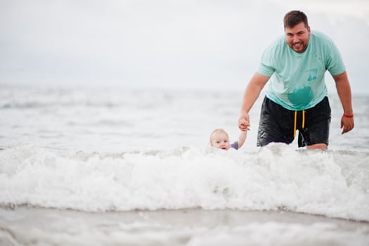 Summer vacations. Parents and people outdoor activity with children. Happy family holidays. Father with baby daughter on sea. photo