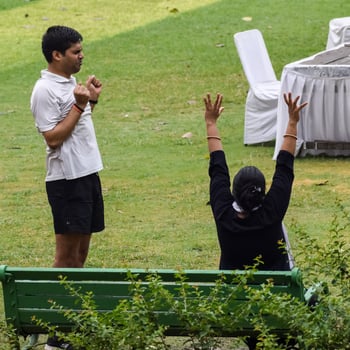 New Delhi, India, June 18 2022 - Group Yoga exercise class Surya Namaskar for people of different age in Lodhi Garden, International Yoga Day, Big group of adults attending a yoga class in park photo