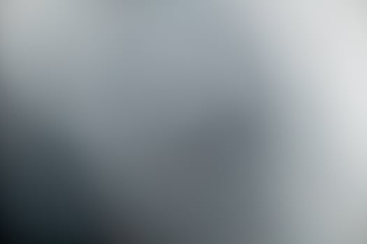 Dark black and gray blurred  gradient background has a little abstract light. photo