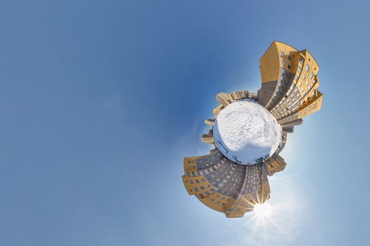 Little planet. Spherical aerial 360 panorama view high-rise building area urban development residential quarter butterfly in winter sunny day on blue background photo